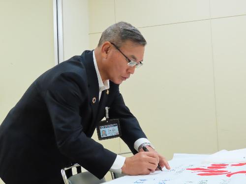 県旗への市長メッセージ記入の様子